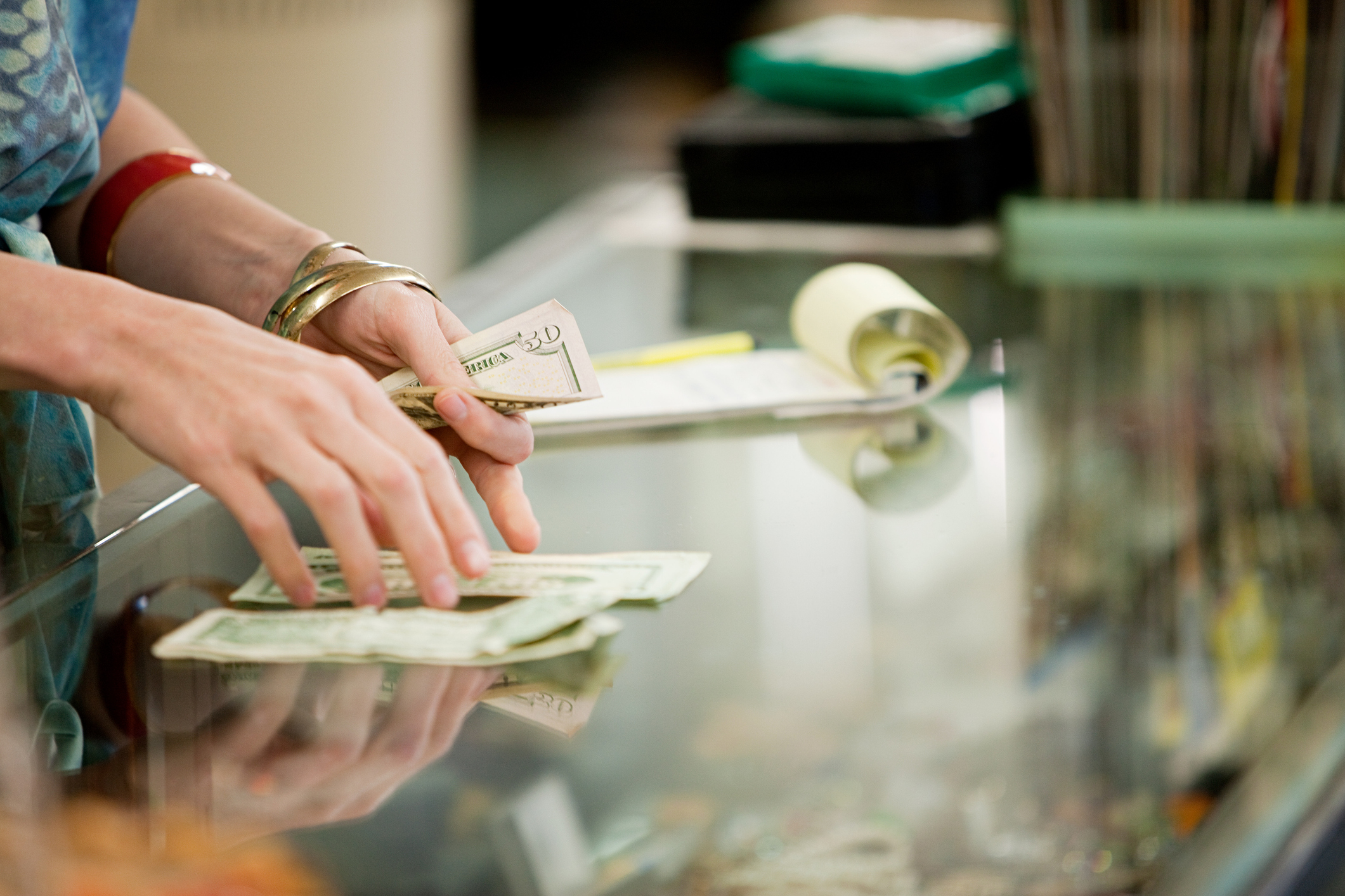 Image of money being left on the table by a merchant