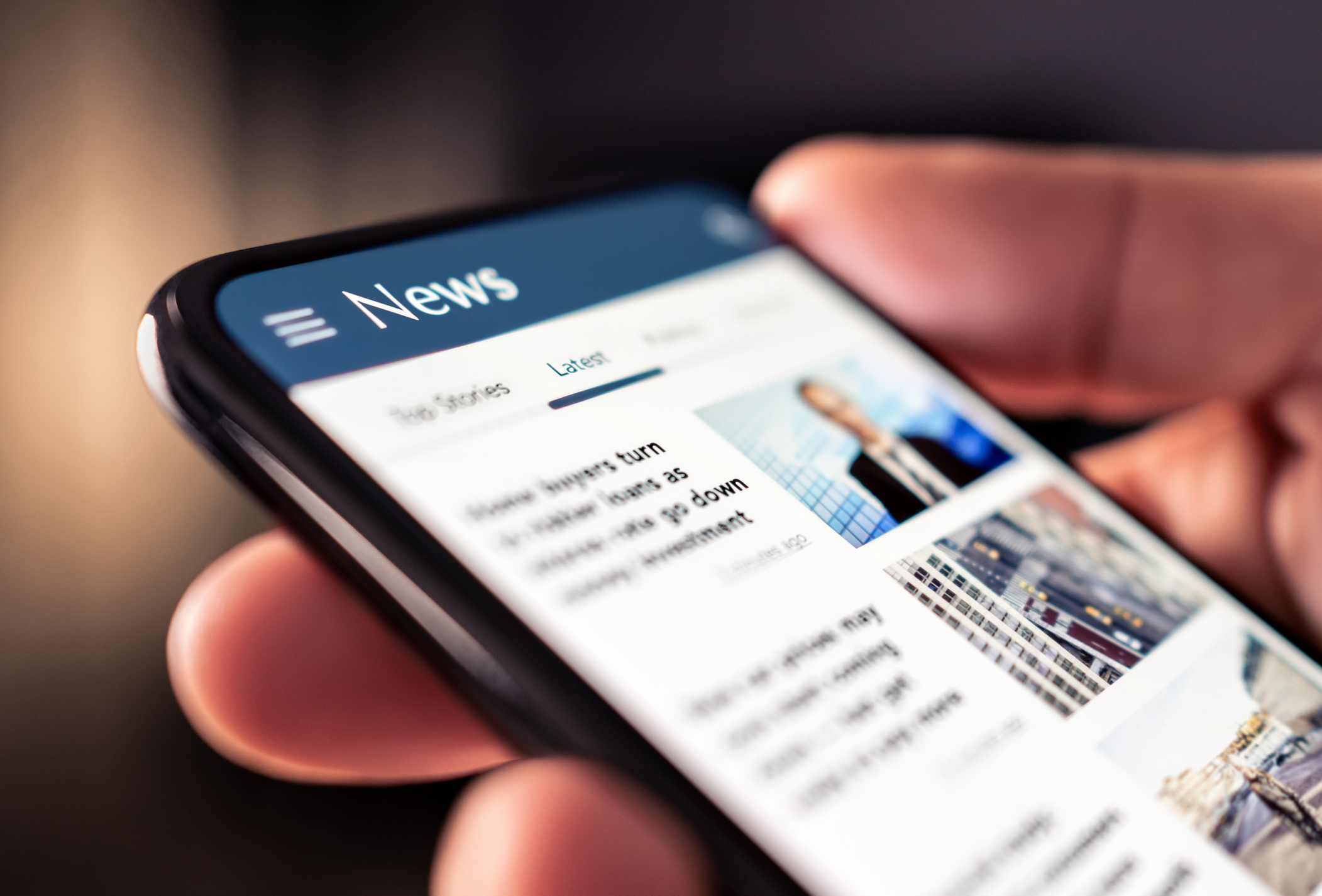 Image of a mobile phone with news on the screen